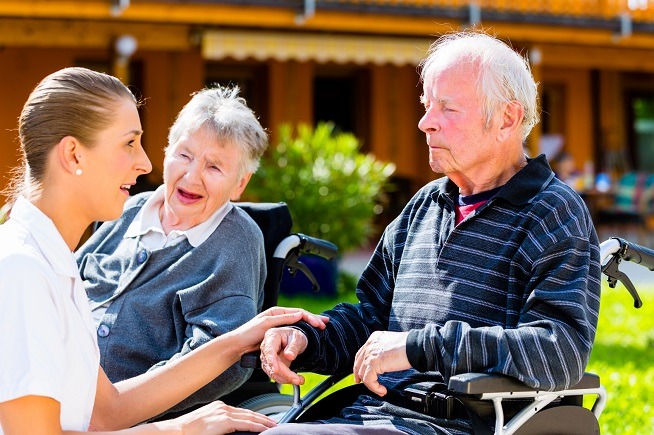 seniors eating candy in garden of nursing home